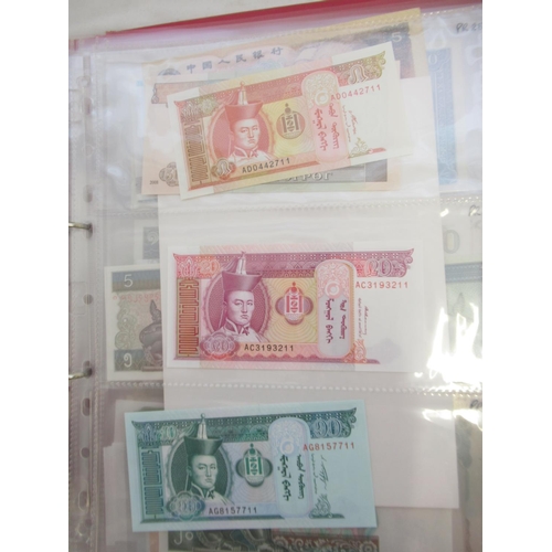 223 - Two folders containing International banknotes from India, Japan, Republic of China, Myanmar, Cambod... 