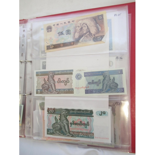 223 - Two folders containing International banknotes from India, Japan, Republic of China, Myanmar, Cambod... 