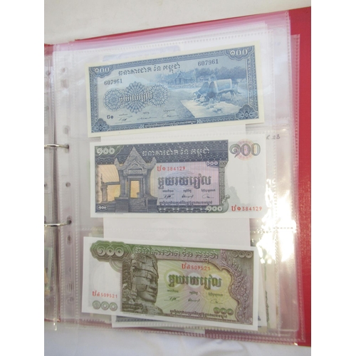 223 - Two folders containing International banknotes from India, Japan, Republic of China, Myanmar, Cambod... 