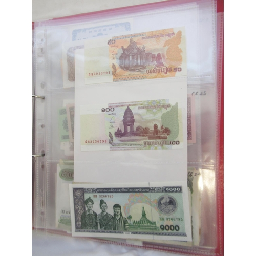 223 - Two folders containing International banknotes from India, Japan, Republic of China, Myanmar, Cambod... 