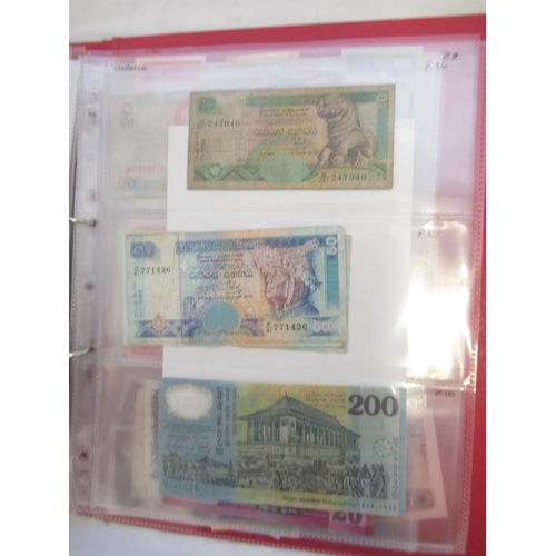 223 - Two folders containing International banknotes from India, Japan, Republic of China, Myanmar, Cambod... 