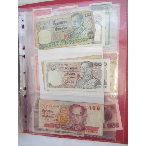 223 - Two folders containing International banknotes from India, Japan, Republic of China, Myanmar, Cambod... 