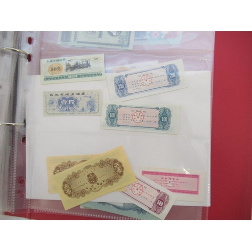 223 - Two folders containing International banknotes from India, Japan, Republic of China, Myanmar, Cambod... 