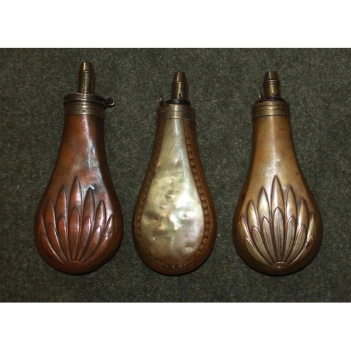 423 - Two copper and brass powder flasks with fluted leaf design and a 'rivet' style flask. All by Sykes.