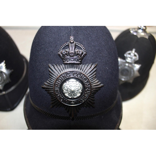 267 - Assortment of police-issue headwear. To include a North Yorkshire police helmet, a North Yorkshire C... 