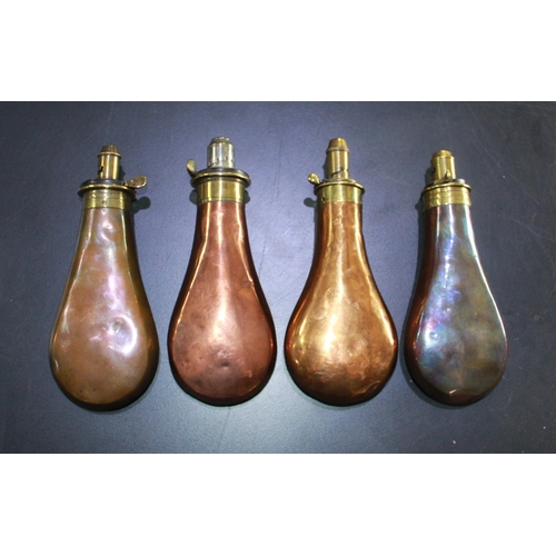 422 - Four brass and copper powder flasks by Sykes, plain bodies.