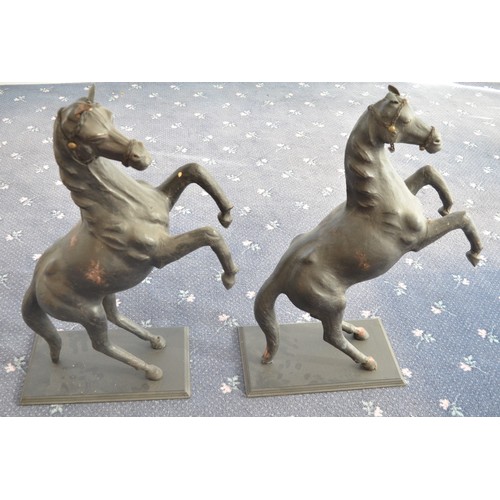 119 - A pair of leather (and possibly papier mache) prancing horses, approx H84cm, bases 25.5x45cm