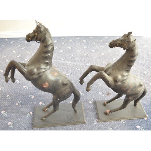 119 - A pair of leather (and possibly papier mache) prancing horses, approx H84cm, bases 25.5x45cm