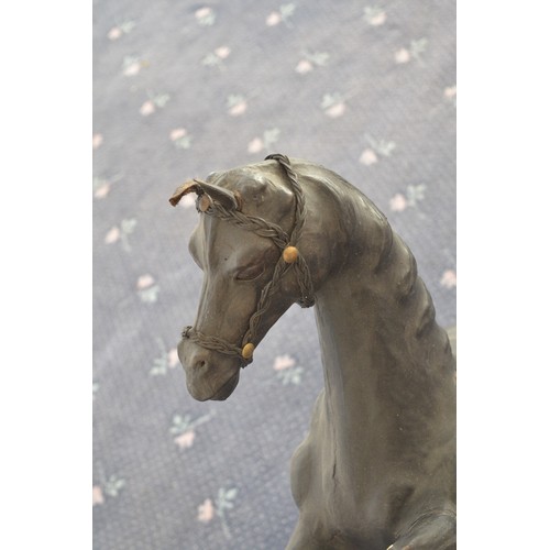 119 - A pair of leather (and possibly papier mache) prancing horses, approx H84cm, bases 25.5x45cm