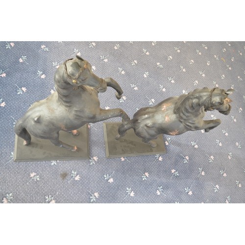 119 - A pair of leather (and possibly papier mache) prancing horses, approx H84cm, bases 25.5x45cm