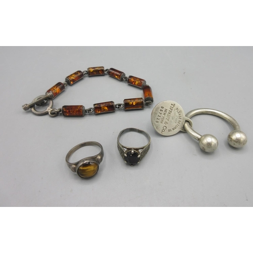 14 - Tiffany keyring with engraving to reverse, an amber and silver toggle closure bracelet and a silver ... 