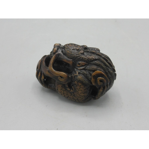 343 - Japanese carved hardwood netsuke in the form of a dragon, inset bone signature panel, L5cm