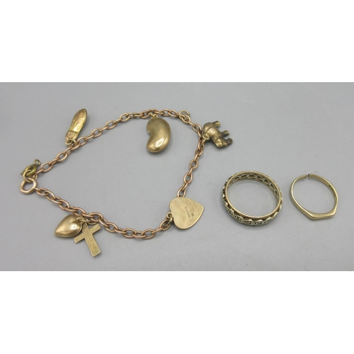 39 - Yellow metal chain bracelet set with five 9ct gold charms, a 9ct gold band ring set with white stone... 