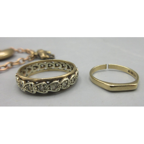 39 - Yellow metal chain bracelet set with five 9ct gold charms, a 9ct gold band ring set with white stone... 