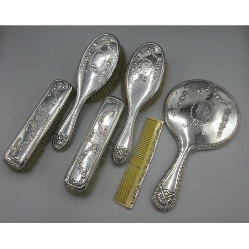 75 - Edwardian silver six piece dressing table set incl four brushes, hand mirror and comb, monogrammed a... 