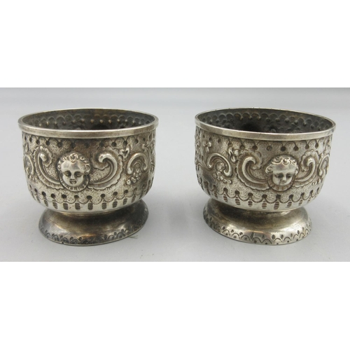 77 - Victorian silver pair of cased salts on pedestal feet, vacant cartouche, repousse scrolls and cherub... 