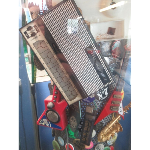 781 - Fossil Classic former display stand filled with badges, and memorabilia inc. The Jam badge , UK Subs... 