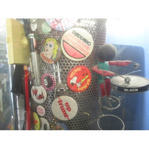 781 - Fossil Classic former display stand filled with badges, and memorabilia inc. The Jam badge , UK Subs... 