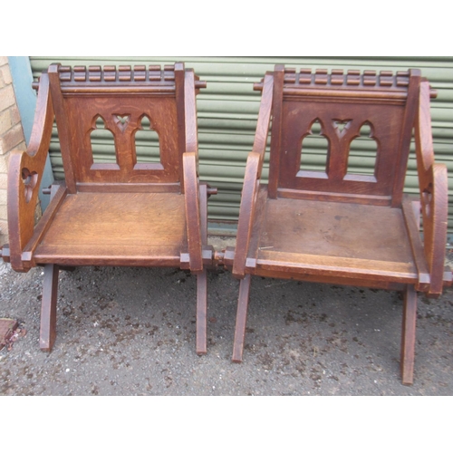 784 - Pair of early 20th century Glastonbury type oak chairs with gothic arched pierced backs on X support... 