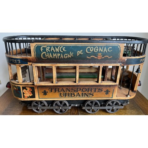 1129 - Painted wood and metal decorative model of a French tram, inscribed ‘Transports Urbains’, L66cm