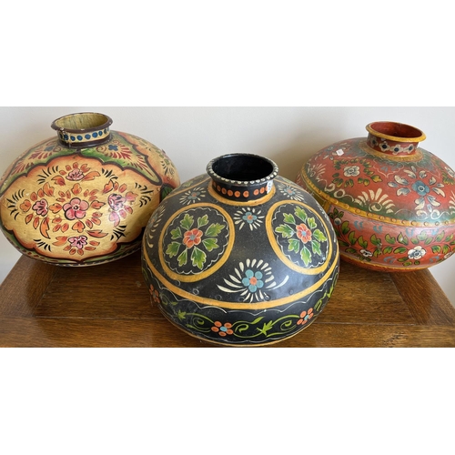 829 - Three Indian painted metal matka (water pots), in orange, red and black, D35cm