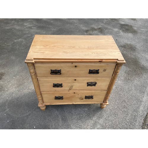 684 - Small pine chest of three long drawers with brass handles on turned feet, W80cm D43cm H78cm