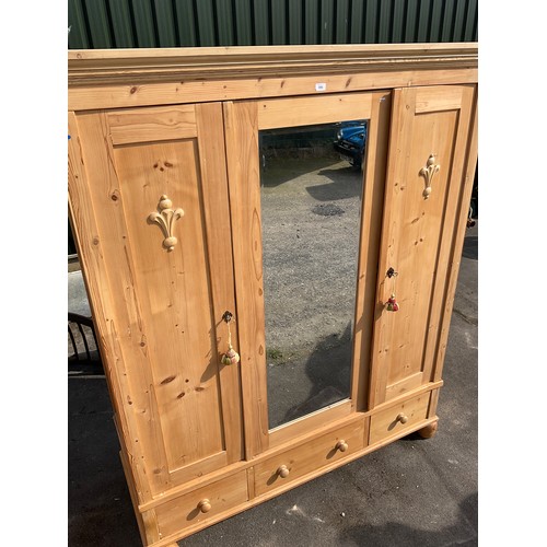 686 - Pine wardrobe, two doors with central mirror above three drawers, on turned feet, W170cm H205cm