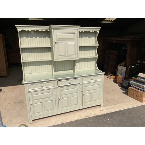 591 - Large Country House style green painted dresser, raised back with four shelves and cupboard, above t... 