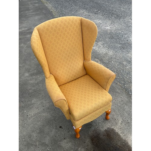 584 - Shackleton's yellow upholstered wing back arm chair on cabriole legs