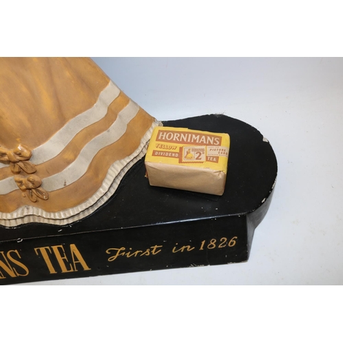 296 - Mid 20th century Hornimans Tea composition advertising sign, modelled as a lady wearing a bonnet and... 