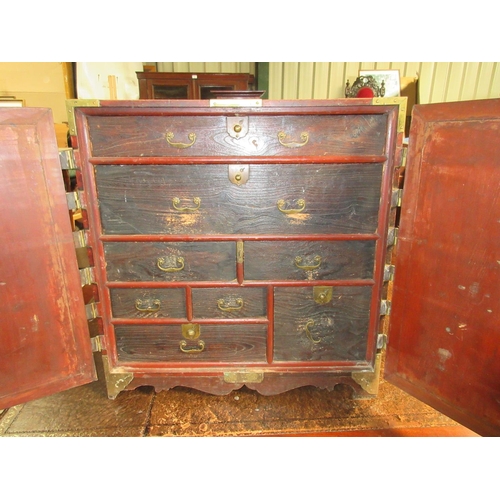 1276 - 20th century Korean brass bound elm table cabinet, two doors enclosing eight drawers, W63cm D36cm D6... 