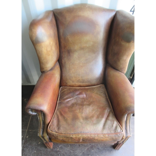 838 - George 111 style brown leather upholstered wing back arm chair, with loose seat cushion square suppo... 