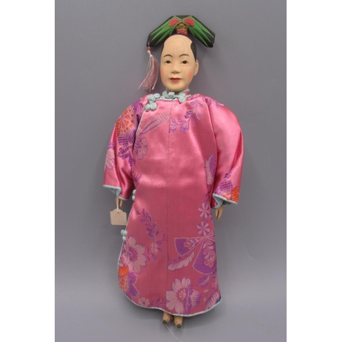 1252 - Chinese 'Door of Hope' doll modelled as Manchurian woman, c1930s, carved pearwood with pink satin co... 