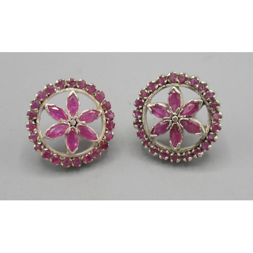 1008 - Silver and ruby floral earrings, the round fronts each set with twenty three round and six marquise ... 