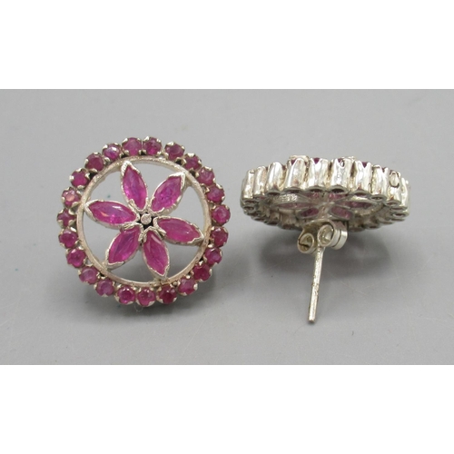 1008 - Silver and ruby floral earrings, the round fronts each set with twenty three round and six marquise ... 