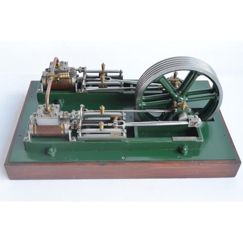 1001 - Twin cylinder horizontal stationary live steam engine with wood clad cylinder housings on wood plint... 