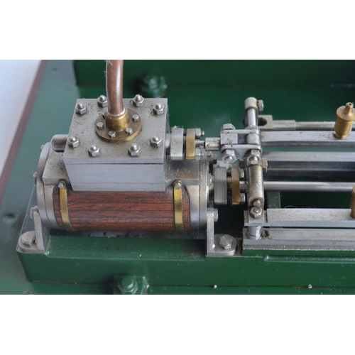 1001 - Twin cylinder horizontal stationary live steam engine with wood clad cylinder housings on wood plint... 