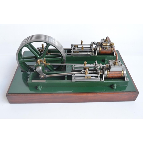 1001 - Twin cylinder horizontal stationary live steam engine with wood clad cylinder housings on wood plint... 