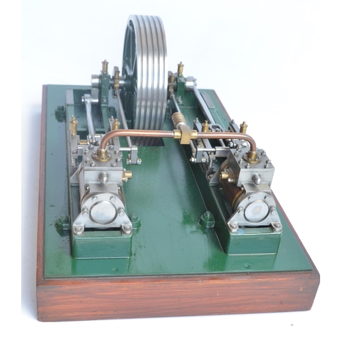 1001 - Twin cylinder horizontal stationary live steam engine with wood clad cylinder housings on wood plint... 