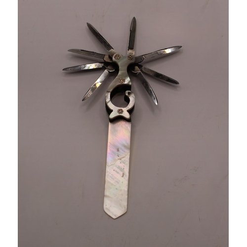 1101 - Victorian mother of pearl letter opener with quill blades, set in an unusual shaped handle with moth... 