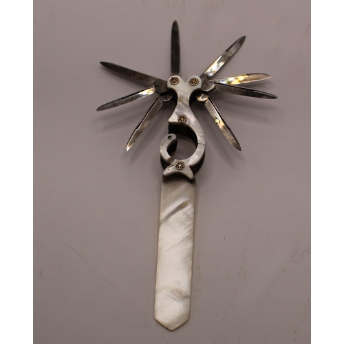 1101 - Victorian mother of pearl letter opener with quill blades, set in an unusual shaped handle with moth... 