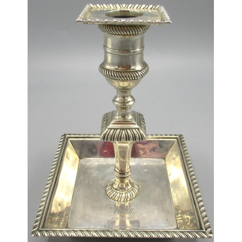 1039 - Edwardian silver candlestick with square dish base stood on four ball feet, baluster stem and gadroo... 