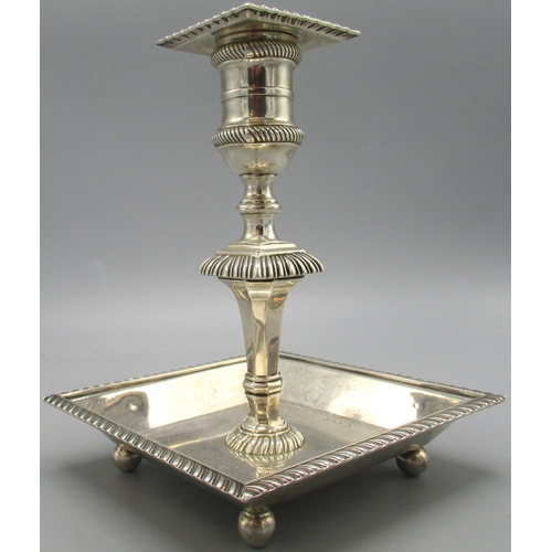 1039 - Edwardian silver candlestick with square dish base stood on four ball feet, baluster stem and gadroo... 