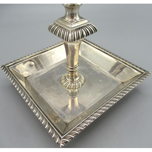 1039 - Edwardian silver candlestick with square dish base stood on four ball feet, baluster stem and gadroo... 