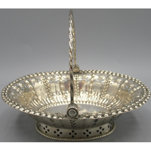 1046 - George III silver basket of oval form, pierced and embossed decoration with twisted swing handle, ra... 