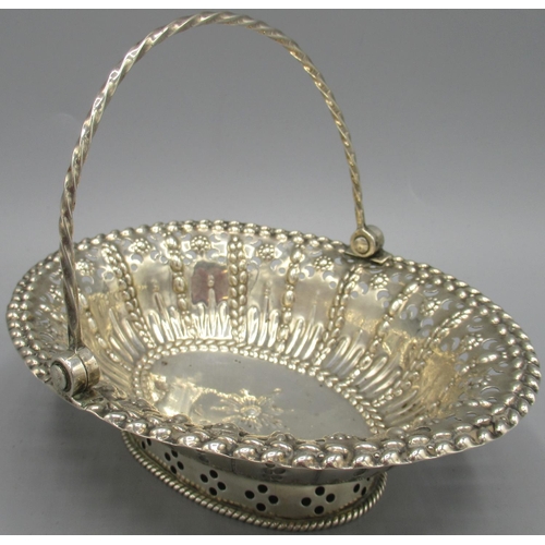 1046 - George III silver basket of oval form, pierced and embossed decoration with twisted swing handle, ra... 