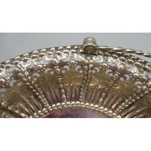 1046 - George III silver basket of oval form, pierced and embossed decoration with twisted swing handle, ra... 