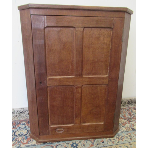 1390 - Derek Fishman Slater of Crayke - a small oak corner cupboard, adzed top and four panel door with two... 