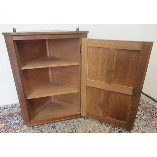 1390 - Derek Fishman Slater of Crayke - a small oak corner cupboard, adzed top and four panel door with two... 