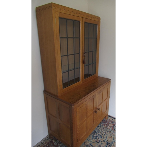 1362 - Robert Mouseman Thompson of Kilburn - a panelled oak side cabinet with penny moulded cornice two lea... 